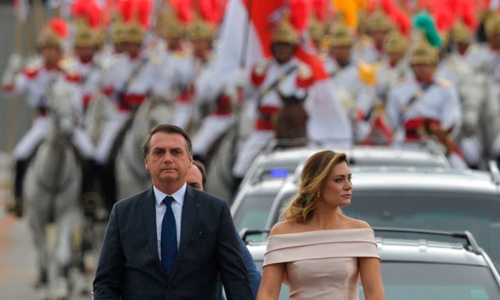 The presidential convoy, led by Brazil's President-elect Jair Bolsonaro (L) and his wife Michelle Bolsonaro in a Rolls Royce, heads to the National Congress for his swearing-in ceremony, in Brasilia on Jan.1, 2019. (Carl De Souza/AFP/Getty Images)