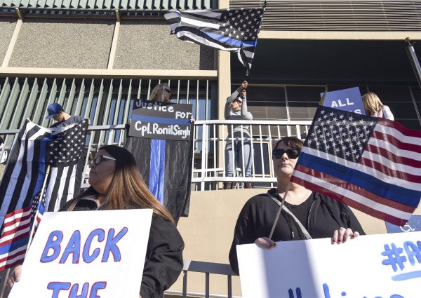 People hold flags and signs