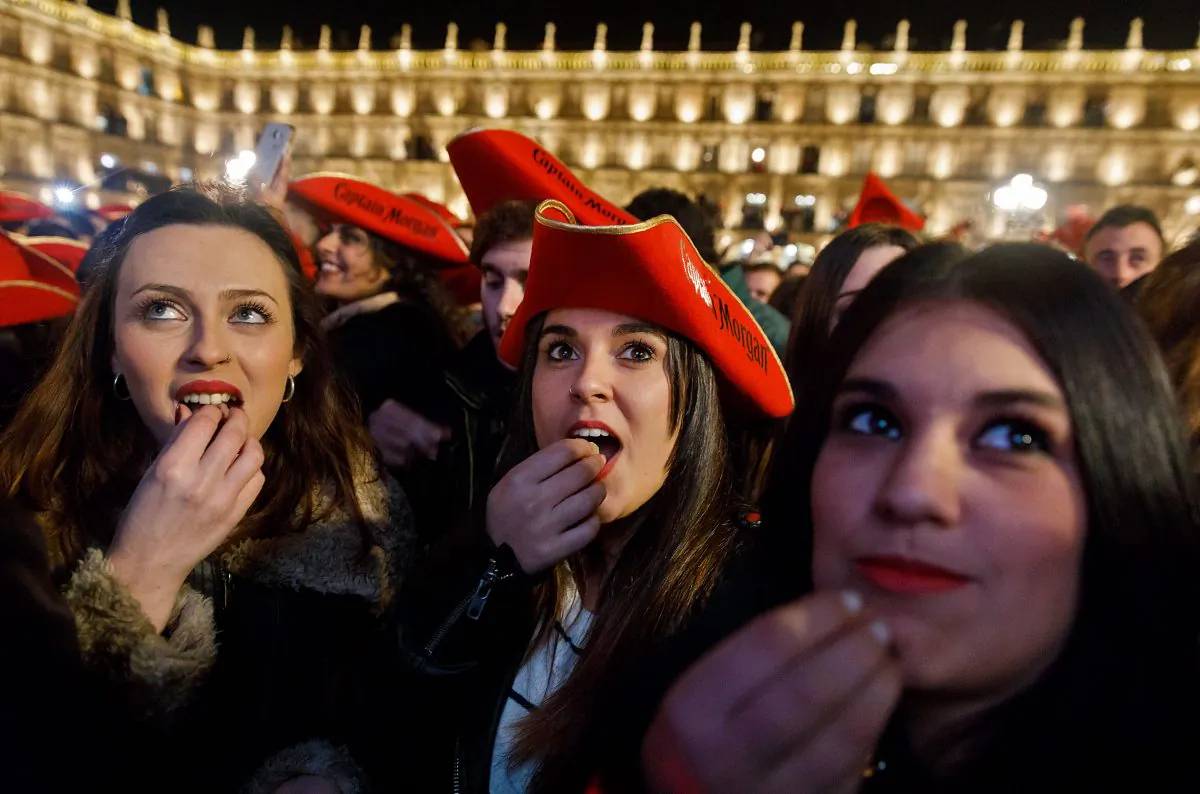 Students eat grape gummies while celebrating the traditional year-end party held in the main square of Salamanca, Spain on Dec. 15, 2016. 
(Cesar Manso/AFP/Getty Images)