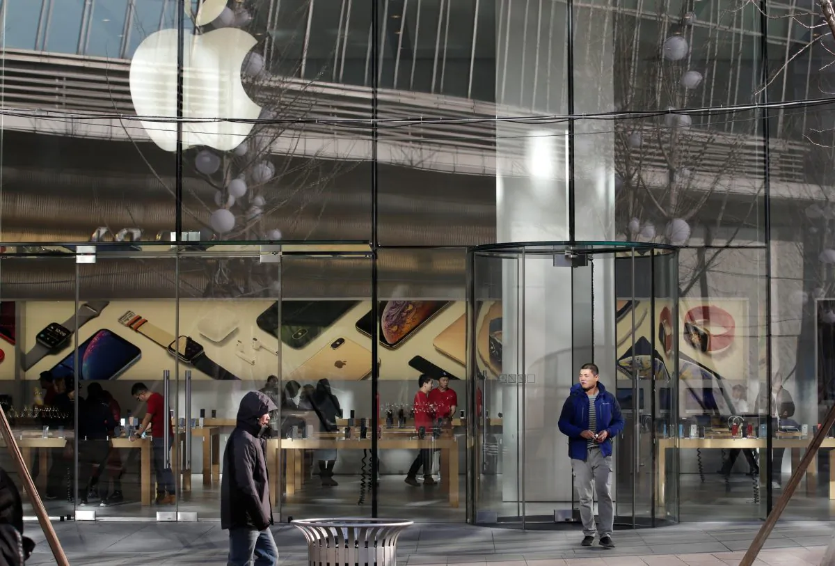 A man walks out of an Apple store in Beijing, on Dec. 14, 2018. (Jason Lee/Reuters)