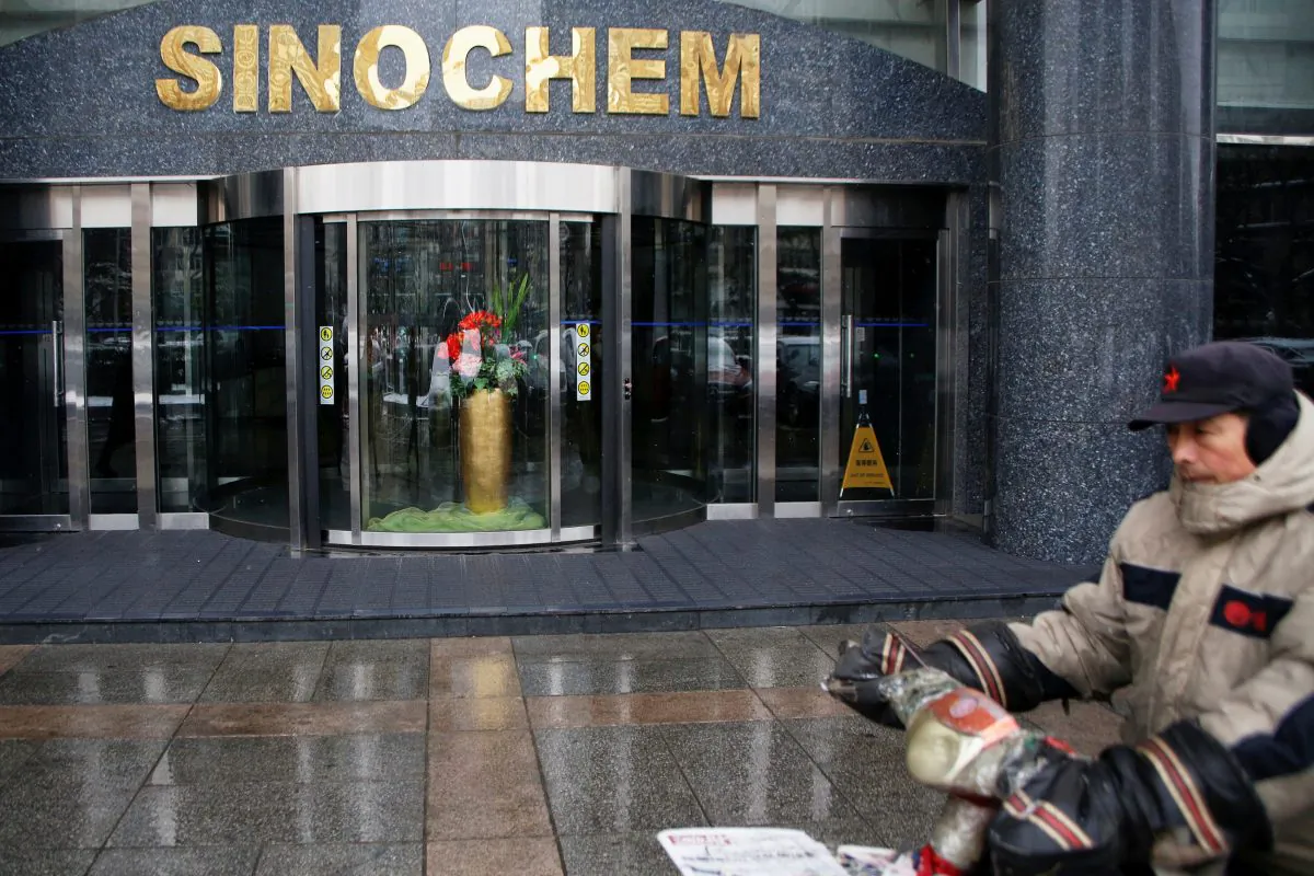 A man rides past the office building of Sinochem in Beijing on Feb. 21, 2017. (Damir Sagolj/Reuters)
