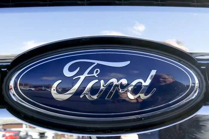 Blue Ford oval badge in the grill of a pickup truck on the sales lot at Butler County Ford in Butler, Pa. On Nov. 19, 2015. (AP Photo/Keith Srakocic)