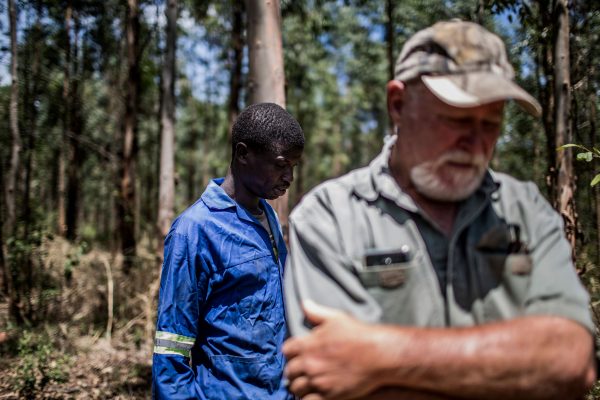 Farm worker Mogoala Justice Ratalele (L) stand near his employer Hans Bergmann after an incident in which he was held at gunpoint for the theft of the chainsaw that he was working with, on Nov. 2, 2017, in Tzaneen, South Africa. A long campaign of violence against the country's farmers, who are largely white, has inflamed political and racial tensions nearly a quarter-of-a-century after the fall of apartheid. (Gulshan Khan/AFP/Getty Images)