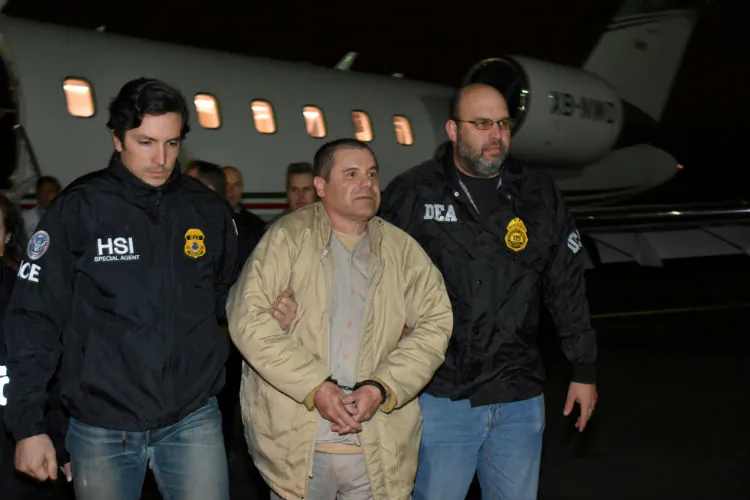 Mexico's top drug lord Joaquin "El Chapo" Guzman is escorted as he arrives at Long Island MacArthur airport in New York, on Jan. 19, 2017, after his extradition from Mexico. (U.S. officials/Handout via Reuters/File Photo)