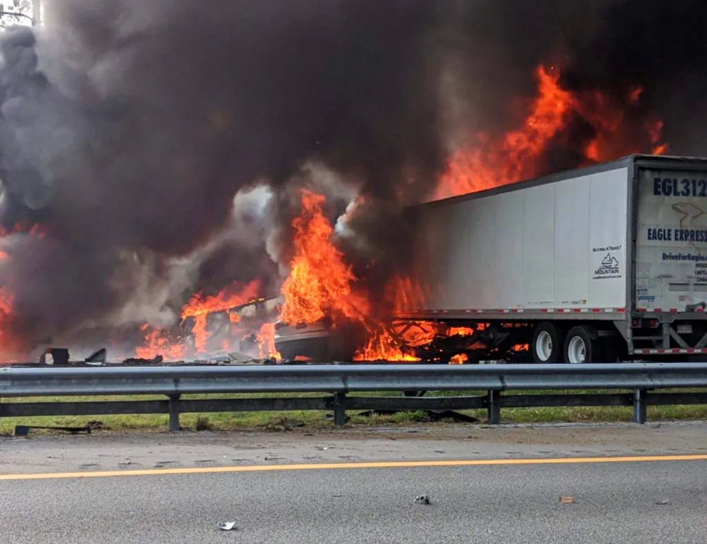 Flames engulf vehicles after a fiery crash along Interstate 75, Thursday, Jan. 3, 2019, about a mile south of Alachua, near Gainesville, Fla. Highway officials say at least six people have died after a crash and diesel fuel spill sparked a massive fire along the Florida interstate. (WGFL-Gainesville/AP)