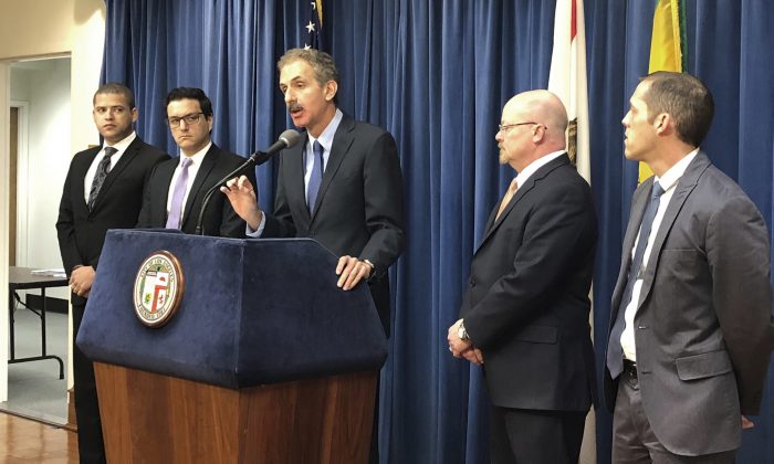 Los Angeles City Attorney Mike Feuer, at podium, speaks at a news conference in Los Angeles, on Jan. 4, 2019. (Brian Melley/Associated Press)