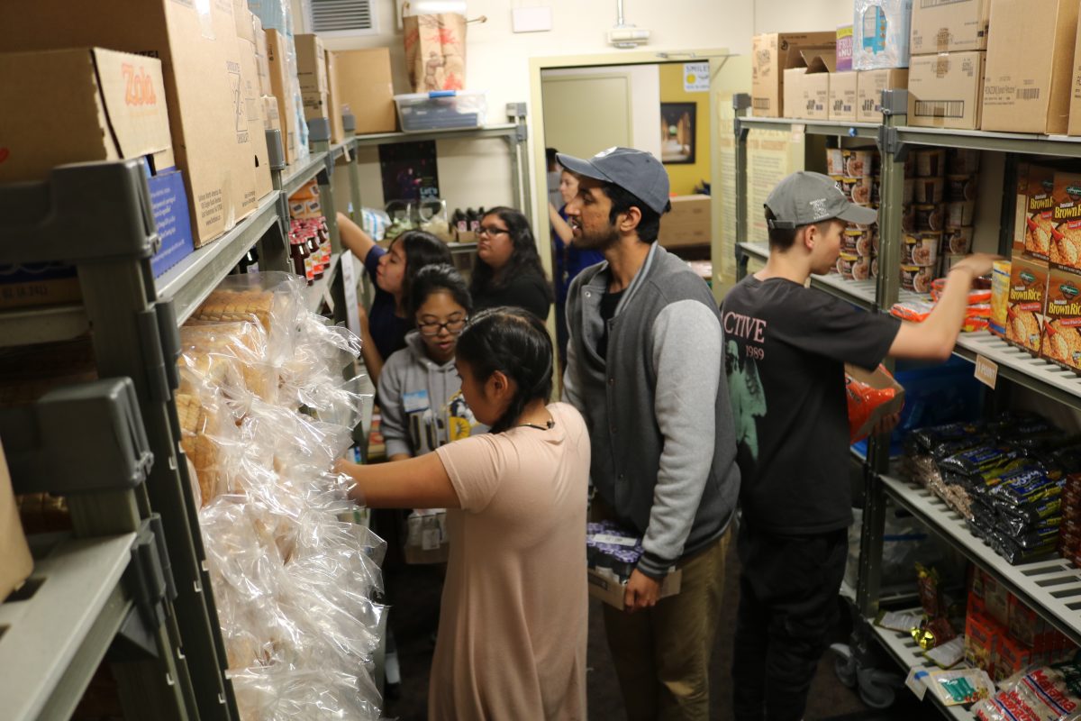 Members of Swipe Out Hunger stock the shelves of the R'Pantry at the University of California-Riverside. (Courtesy of the University of California-Riverside)