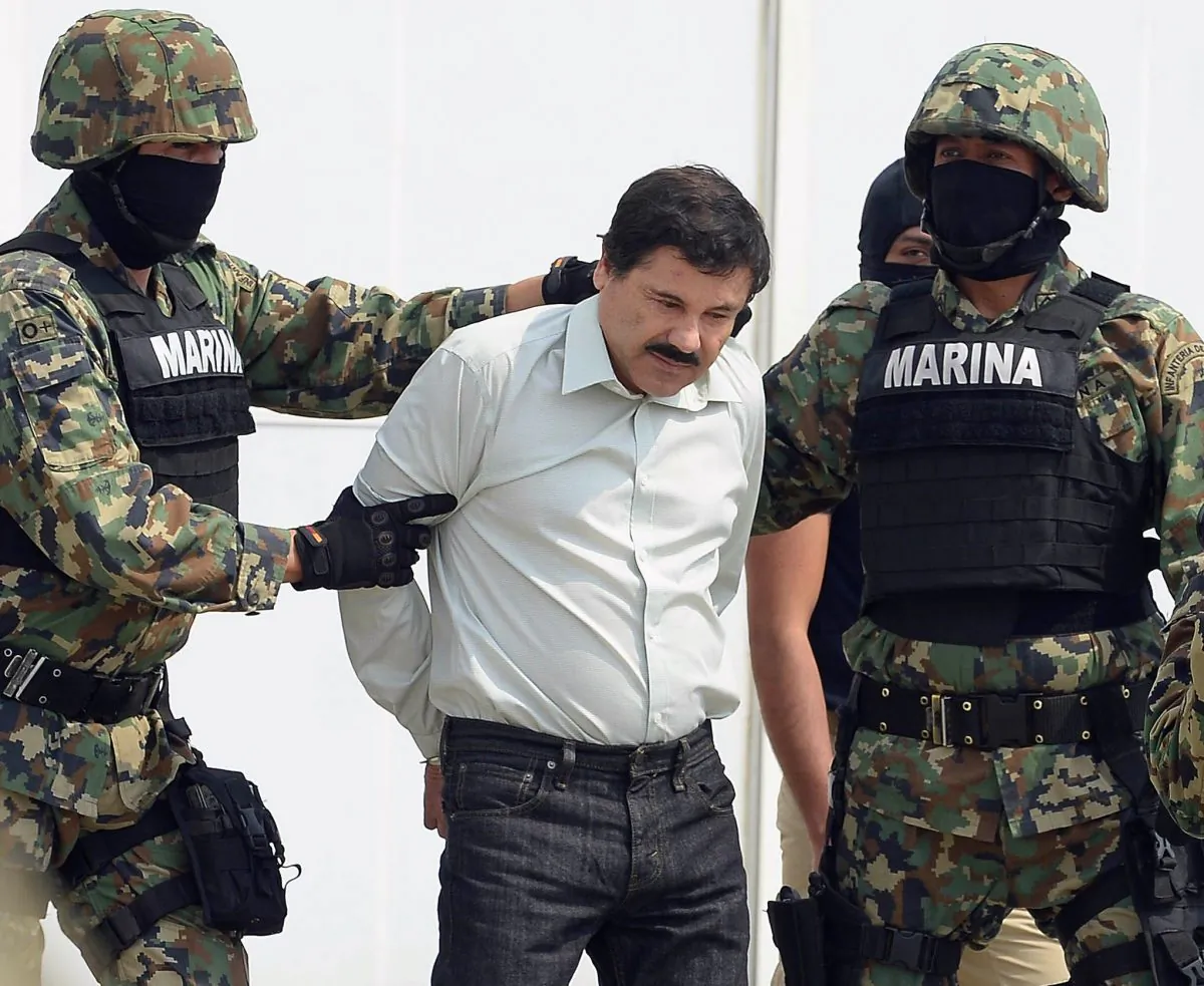 Mexican drug trafficker Joaquin Guzman Loera (el Chapo Guzman), is escorted by Marines as he is presented to the press in Mexico City on Feb. 22, 2014. (Alfredo Estrella/AFP/Getty Images)