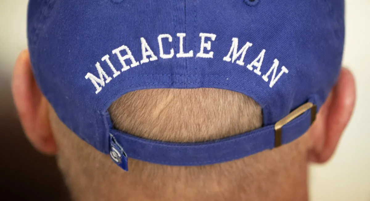 In this Thursday, Jan. 3, 2019 photo, T. Scott Marr wears a miracle man hat during a press conference in Omaha, Neb. Thought to be brain dead, Marr awakened after being taken off life support. (Kent Sievers/Omaha World-Herald/AP)