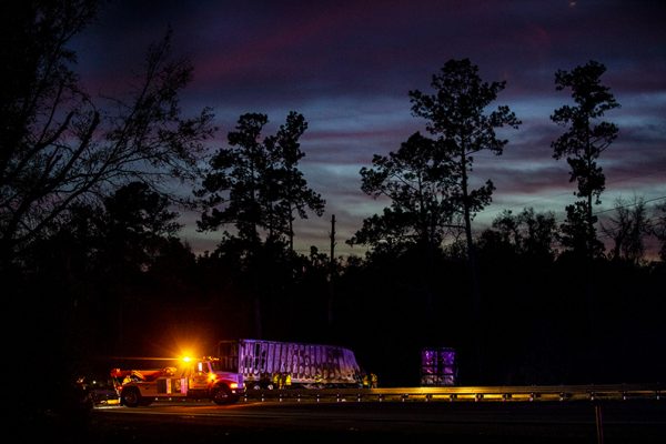 Workers labor into the night to clear the wreckage