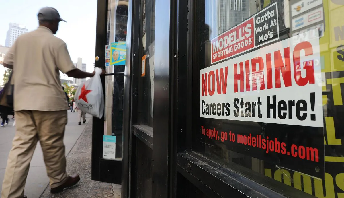 A now hiring sign is displayed in the window of a Brooklyn business in New York on Oct. 5, 2018. (Spencer Platt/Getty Images)