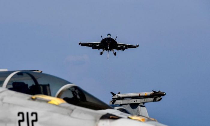 A F18 Hornet fighter jet prepares to land on the deck of the US navy aircraft carrier USS Harry S. Truman in the eastern Mediterranean Sea on May 8, 2018. The USS Harry S. Truman Carrier Strike Group on May 3 began air operations in support of Operation Inherent Resolve, conducting flight operations against the so called Islamic State (IS) targets in Syria and Iraq. (ARIS MESSINIS/AFP/Getty Images)