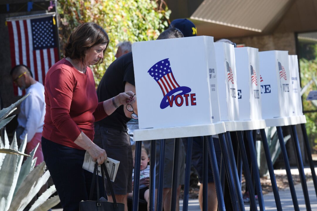 People vote at outdoor booths during early voting for the mid-term elections in Pasadena, Calif., on Nov. 3, 2018. (Mark Ralston/AFP/Getty Images)