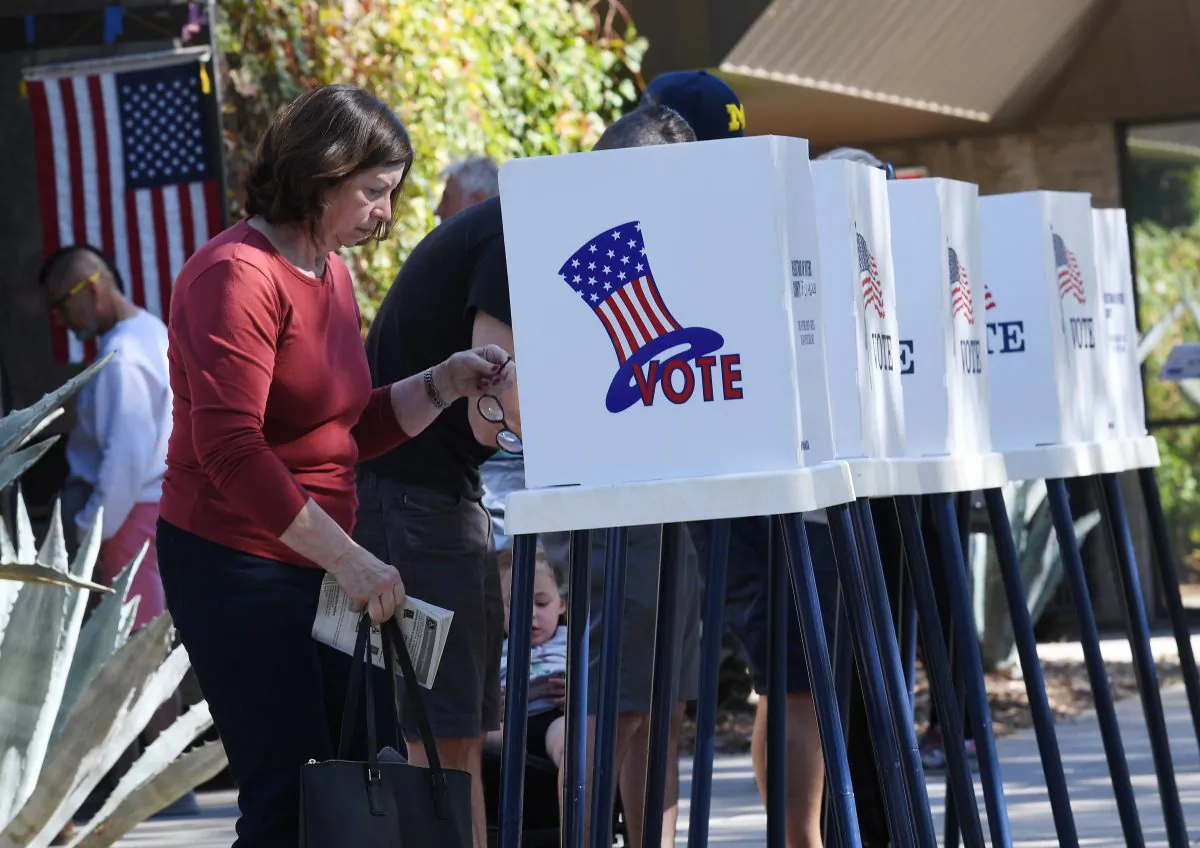 People vote at outdoor booths during early voting for the mid-term elections in Pasadena, California on Nov. 3, 2018. (MARK RALSTON/AFP/Getty Images)