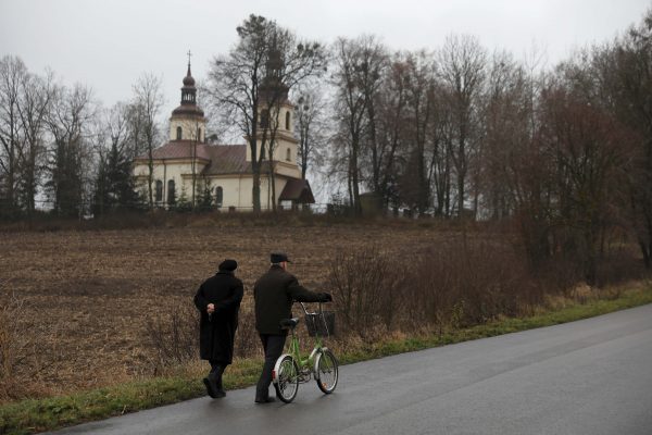 People go to a mass in Kalinowka, Poland