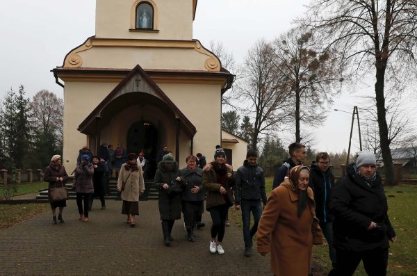 Parishioners leave the church after the mass in Kalinowka, Poland