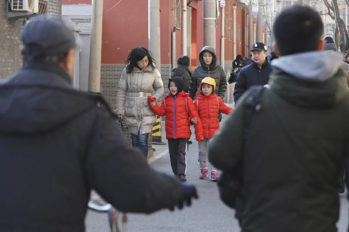 Children are escorted from the site of an attack at the Beijing No. 1 Affiliated Elementary School of Xuanwu Normal School in Beijing on Jan. 8, 2019. A male attacker injured 20 children inside the primary school in China's capital, officials said. (Ng Han Guan/AP)