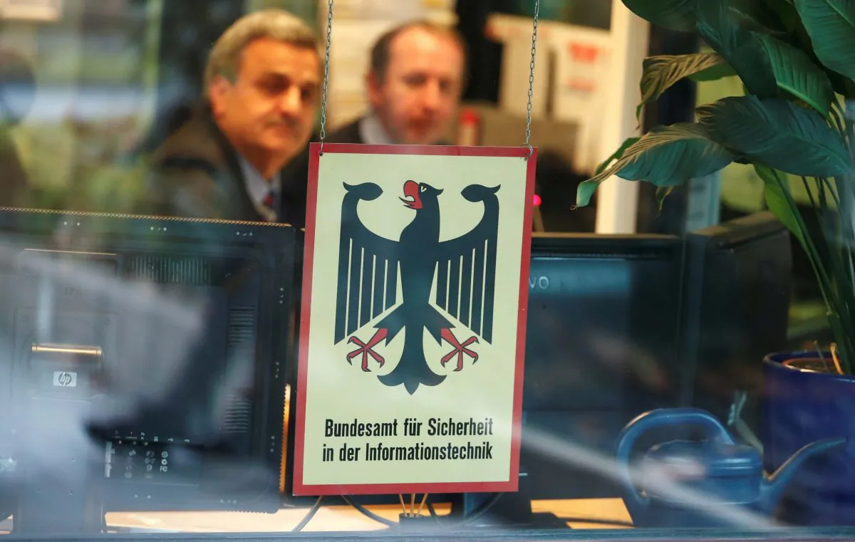Security personnel sit behind bulletproof glass at the headquarters of Germany's BSI national cyber defense body in Bonn, Germany, on Jan. 4, 2019. (Reuters/Wolfgang Rattay/File Photo)