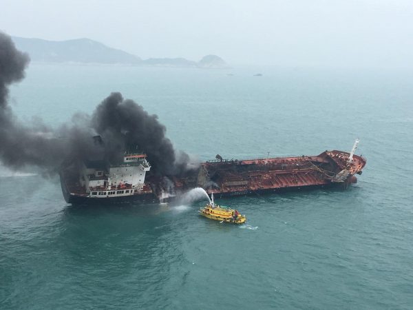 An oil tanker on fire is seen near Lamma island