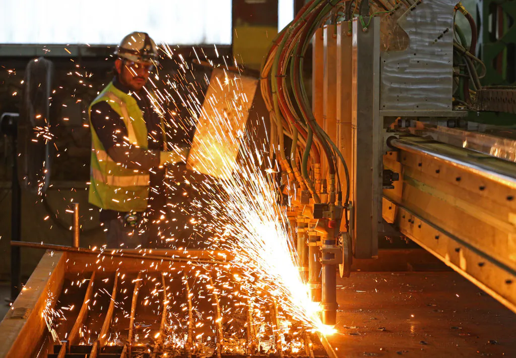A worker at Intsel Steel West, cuts pieces of steel in Salt Lake City, Utah, on Oct. 4, 2018. (George Frey/Getty Images)