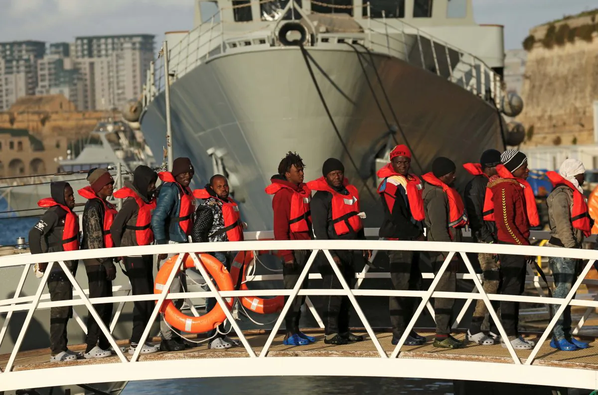 Migrants who were stranded on the NGO migrant rescue ships Sea-Watch 3 and Professor Albrecht Penck disembark from an Armed Forces of Malta patrol boat at its base in Marsamxett Harbour, Valletta, Malta, on Jan. 9, 2019. (Reuters/Darrin Zammit Lupi)