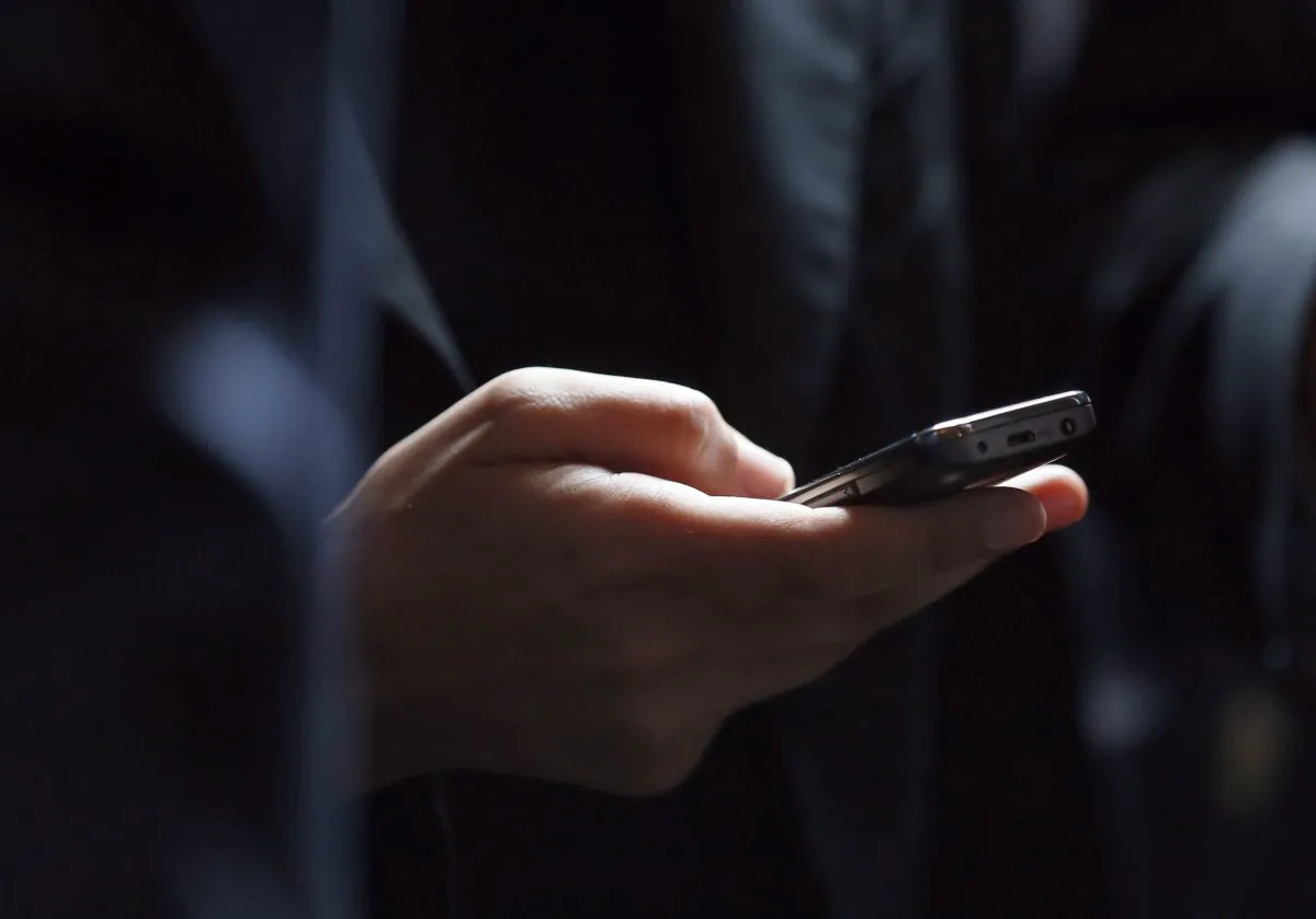 A person holds a cell phone in a file photo. (Kenzo Tribouillard/AFP/Getty Images)