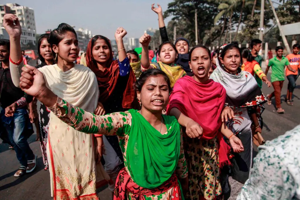 Bangladeshi striking garments workers march in the streets of Dhaka on Jan. 8, 2019 during a third day of demonstration to demand wage hikes. - Bangladesh's 4,500 textile and clothing factories exported more than $30 billion worth of apparel last year, making clothing for retailers such as H&M, Walmart, Tesco, Carrefour and Aldi. (Abdullah Apu/AFP/Getty Images)