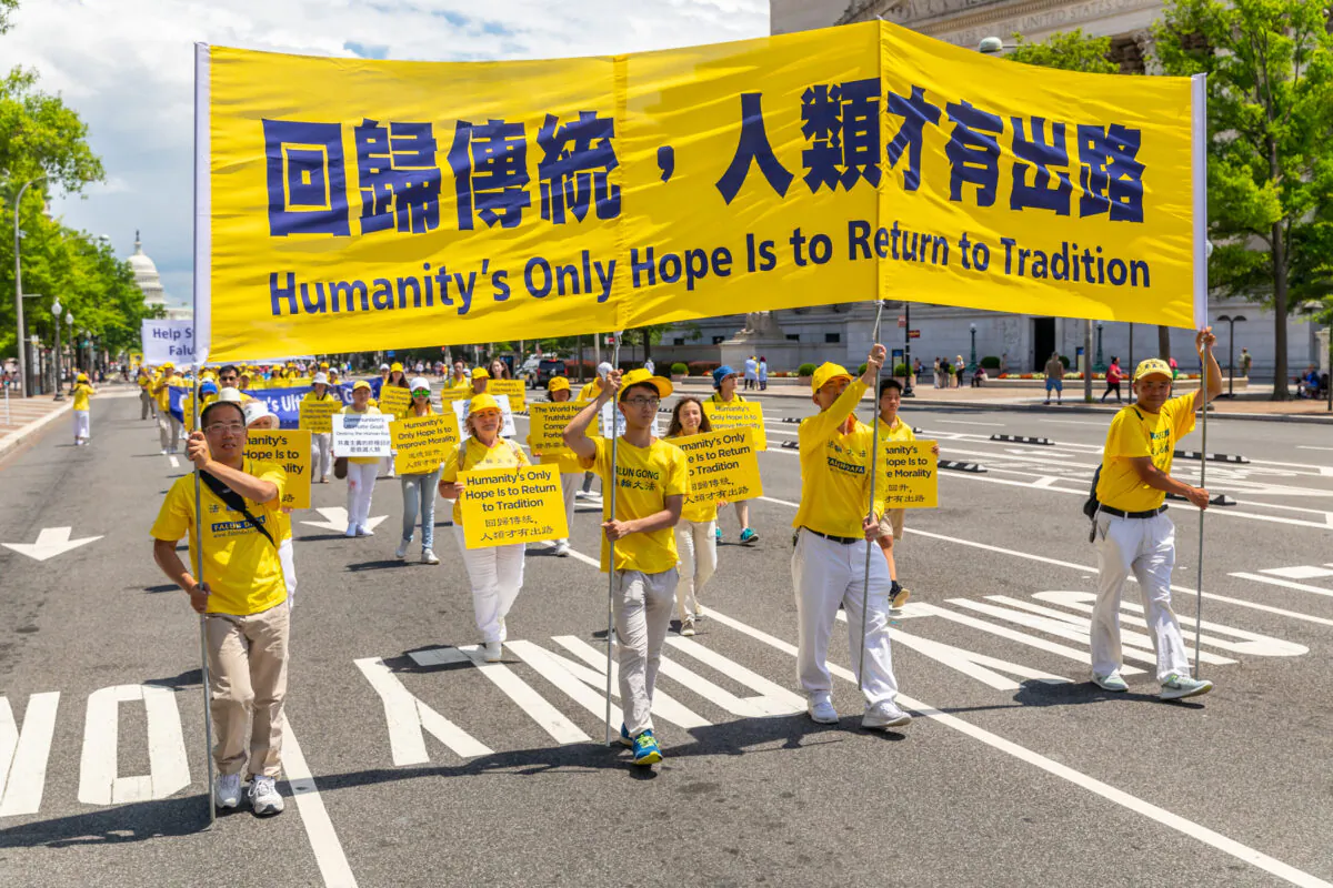 Falun Gong practitioners take part in a parade commemorating the 20th anniversary of the persecution of Falun Gong in China, in Washington on July 18, 2019. (Mark Zou/The Epoch Times)