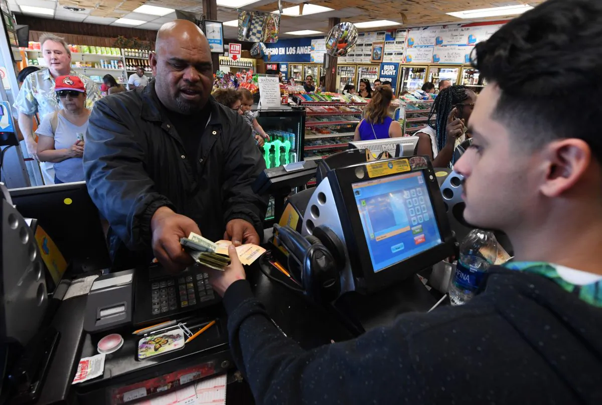 A man purchases lottery tickets in a liquor store in Torrance, Calif., on Oct. 19, 2018. (MARK RALSTON/AFP/Getty Images)