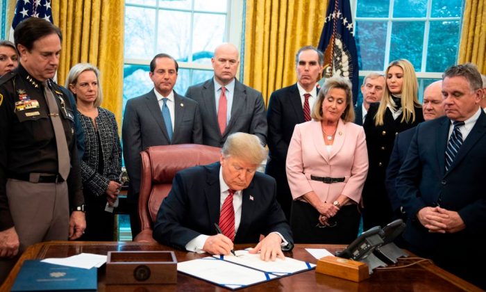 President Donald Trump signs a bill for Anti-Human Trafficking Legislation at White House in Washington, DC, on January 9, 2018.  (Jim Watson/AFP/Getty Images)