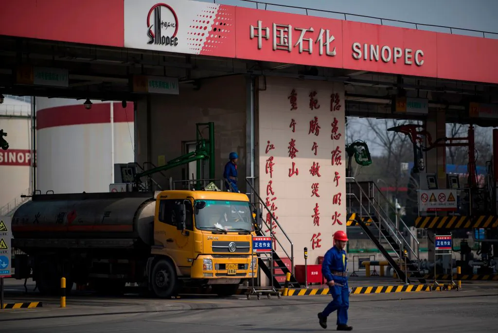 A man works at a gas station of Sinopec in Shanghai on March 22, 2018. (Johannes Eisele/AFP/Getty Images)