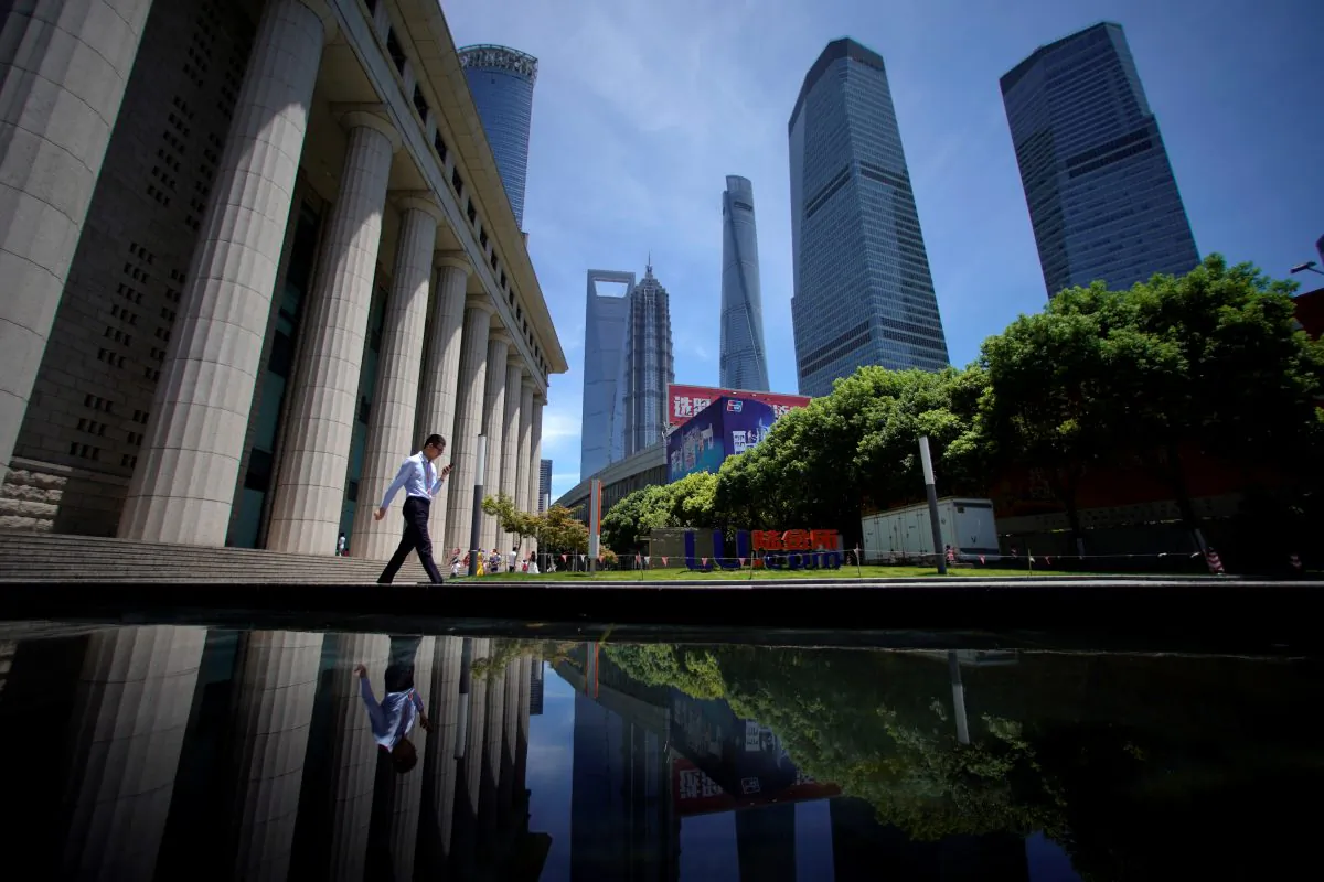 A man walks at Lujiazui financial district of Pudong in Shanghai on July 17, 2017. (Aly Song/Reuters)