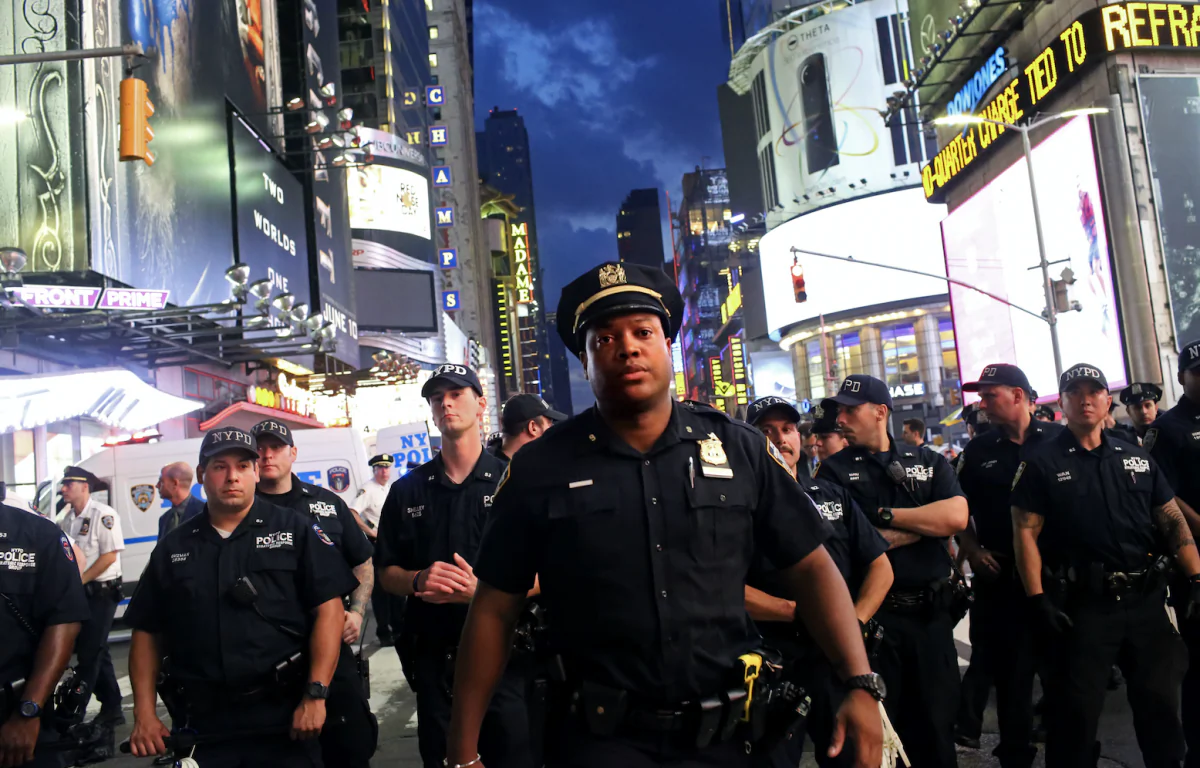 Police watch activists protest in Times Square in response to the recent fatal shootings of two black men by police in New York City, on July 7, 2016. (Yana Paskova/Getty Images)