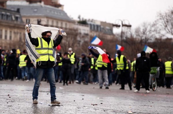 Protesters wearing yellow vests take part in a demonstration by the "yellow vests" movement near the Arc de Triomphe in Paris