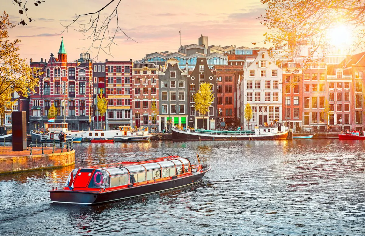 Colorful buildings line Amstel River in Amsterdam. (Shutterstock)