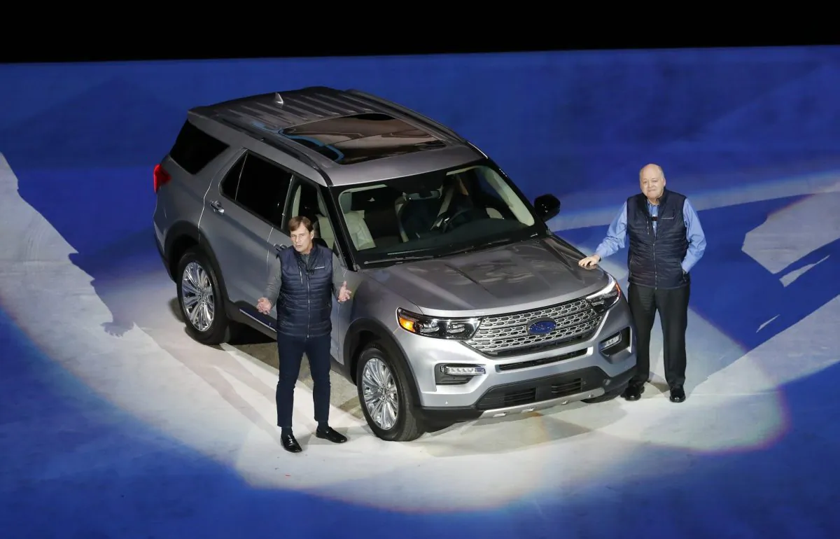 Ford Motor Co., President, Global Markets Jim Farley, left, and President and CEO Jim Hackett stand next to the redesigned 2020 Ford Explorer during its unveiling, in Detroit. (AP Photo/Carlos Osorio)