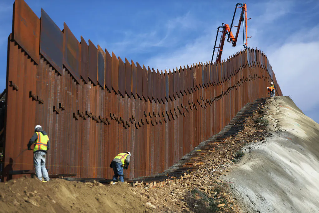 A construction crew works as new sections of the U.S.-Mexico border barrier are installed replacing smaller fences, as seen from Tijuana, Mexico, on Jan. 11, 2019. (Mario Tama/Getty Images)