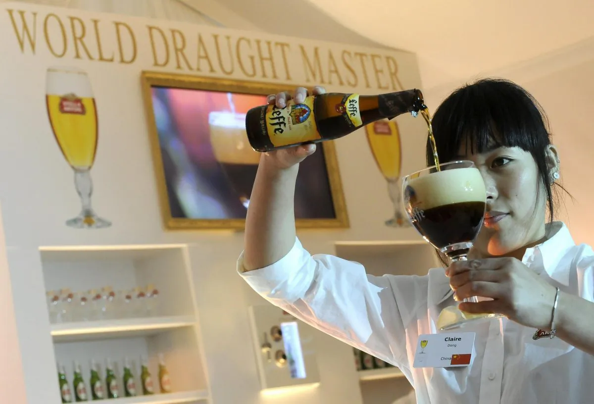 A contestant serves a Leffe beer during the Stella Artois World Draught Master 2008 on Oct. 29, 2008, in Leuven, Belgium. An alcohol-free version of world-famous Leffe brand is now available. (BENOIT DOPPAGNE/AFP/Getty Images)