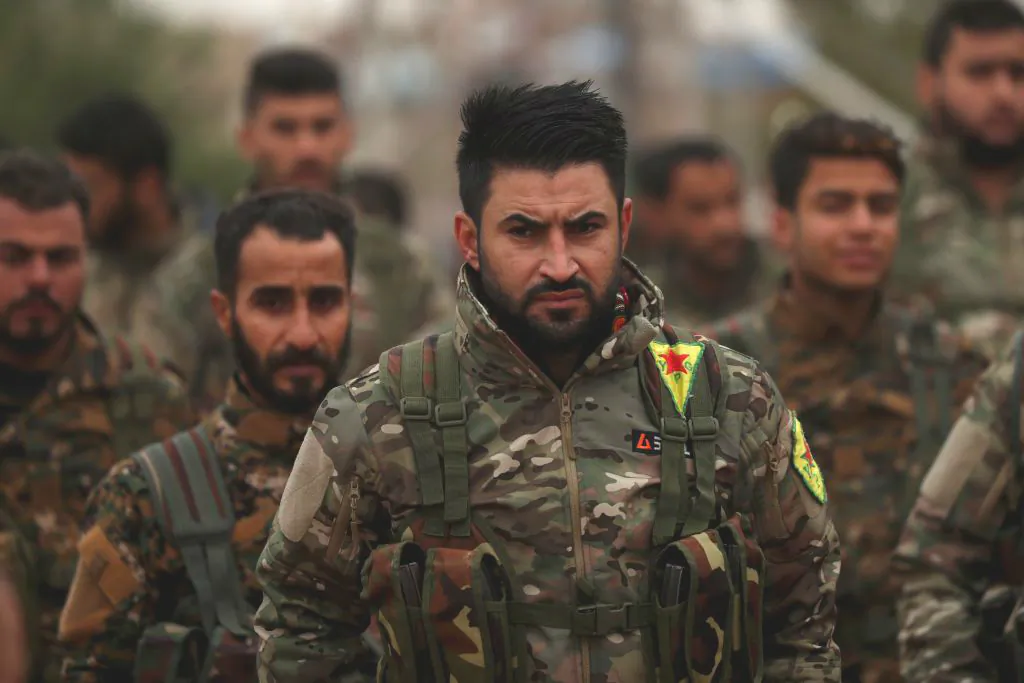 Fighters from the Syrian Democratic Forces (SDF) attend the funeral of a local official that the SDF say was assassinated in a Kurdish-held area in the countryside of Deir Ezzor, in the Syrian Kurdish-majority city of Qamishli on Dec. 31, 2018. (Delil Souleiman/AFP/Getty Images)