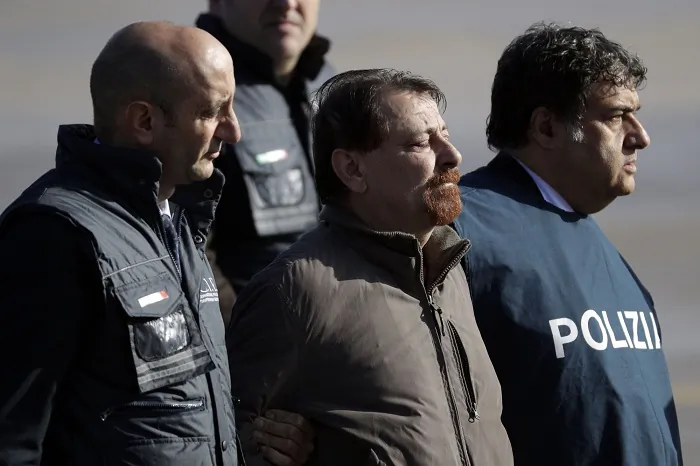 Italian fugitive Cesare Battisti arrives at Ciampino military airport, in Rome, on Jan. 14, 2019. Battisti a left-wing Italian militant who was convicted of murder three decades ago is heading home to serve a life sentence, after his life as a celebrity fugitive came to an abrupt end with his arrest in Bolivia by a team of Interpol agents. (Gregorio Borgia/AP Photo)