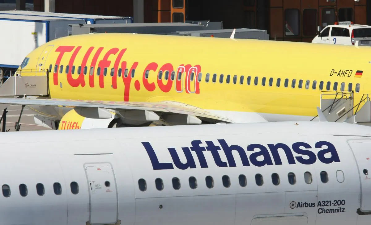 Passenger planes of German airliners Lufthansa and TUI pass one another at Tegel Airport in Berlin, Germany, on July 29, 2008. (Sean Gallup/Getty Images)