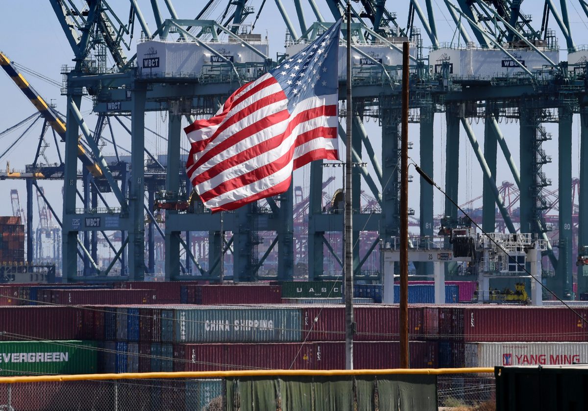 The U.S. flag flies over Chinese shipping containers that were unloaded at the Port of Long Beach, in Los Angeles County, U.S. on Sept. 29, 2018. (Mark Ralston/AFP/Getty Images)