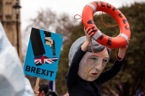 A demonstration featuring a papier mache Theresa May