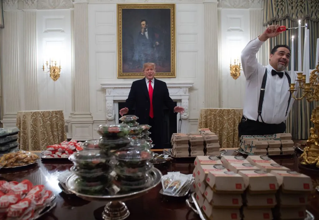 President Donald Trump speaks alongside fast food he purchased for a ceremony honoring the 2018 College Football Playoff National Champion Clemson Tigers in the State Dining Room of the White House in Washington, on Jan. 14, 2019. (Saul Loeb/AFP/Getty Images)