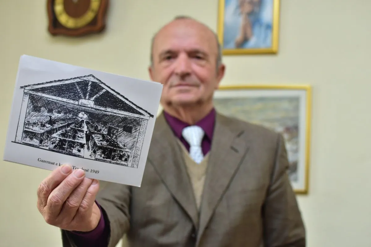 Simon Mirakaj holds the drawings from Tepelena camp in his office. (Antonio Çakshiri for The Epoch Times)