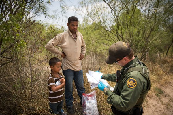 Border Patrol Agent takes down information