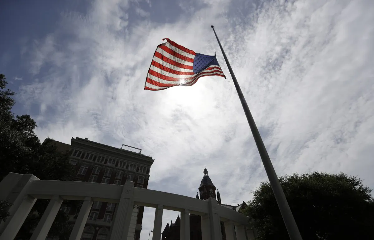 A flag flies at half-staff over Dealey Plaza in Dallas in a July 9 file photo. (AP Photo/Eric Gay)