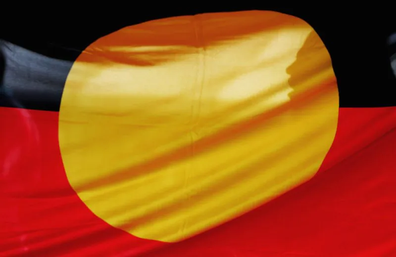 File photo: A woman is silhouetted behind the Aboriginal flag in Sydney, Australia on May 26, 2006.  (Ian Waldie/Getty Images)