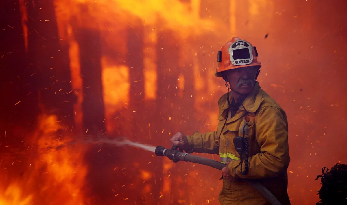 A firefighter calls for water as most of the homes in the Oakridge mobile home park. (David McNew/Getty Images)