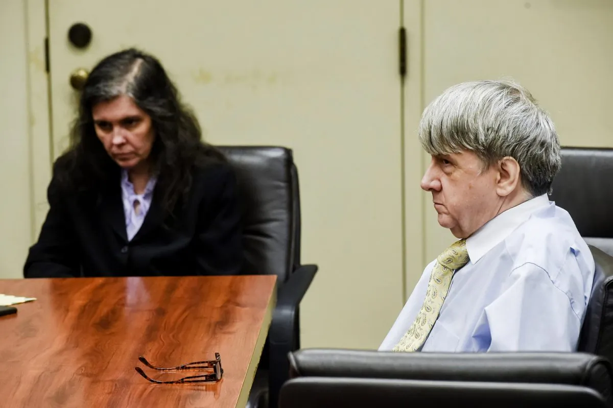 Defendants David Turpin, right, and wife, Louise, appear in Riverside Superior Court during an information hearing on charges that include torture and child abuse in Riverside, Calif., on Aug. 3, 2018. (Watchara Phomicinda/The Orange County Register via AP)